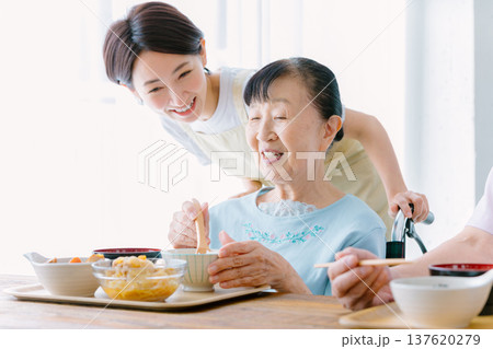 介護士と食事をするシニア女性 介護士と食事をするシニア女性 137620279