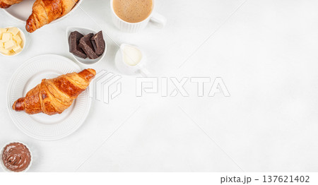 Croissant breakfast with coffee chocolate spread and butter top view Croissant breakfast with coffee chocolate spread and butter top view 137621402
