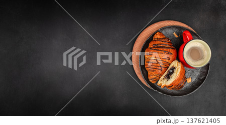 Chocolate croissant with coffee on dark background breakfast flat lay 137621405