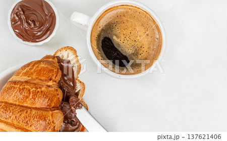 Croissant with chocolate spread and coffee top view breakfast 137621406