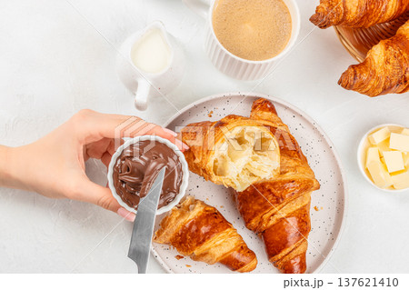 Chocolate spread and croissant breakfast with coffee top view 137621410