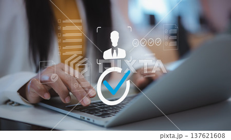 Digital recruitment and candidate verification process.HR technology for employee system.Verified user profile and professional candidate screening.Businesswoman using laptop for talent acquisition. Digital recruitment and candidate verification process.HR technology for employee system.Verified user profile and professional candidate screening.Businesswoman using laptop for talent acquisition. 137621608