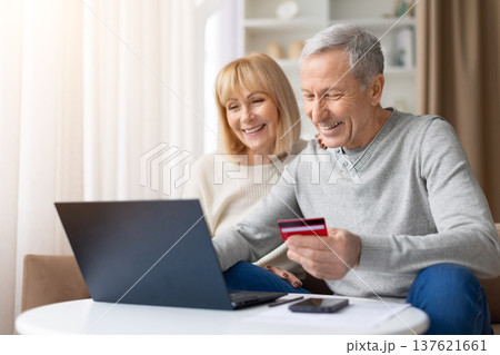Senior couple making online payment using laptop and credit card at home Senior couple making online payment using laptop and credit card at home 137621661