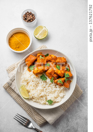 Chicken tikka masala curry with rice on light concrete background 137621792