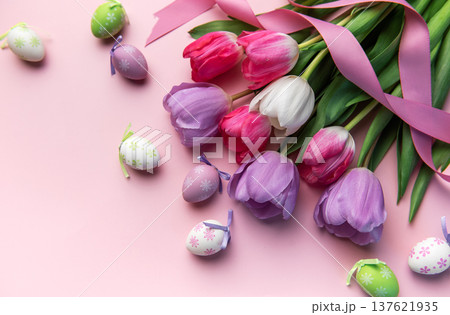 Colorful easter eggs and spring tulips on a pink background Colorful easter eggs and spring tulips on a pink background 137621935