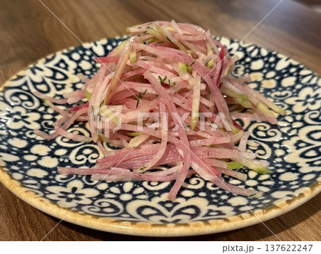 Radish salad on decorative plate with julienned vegetables in vibrant colors for food presentation Radish salad on decorative plate with julienned vegetables in vibrant colors for food presentation 137622247