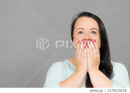 Shocked woman covering her mouth with hand 137623638