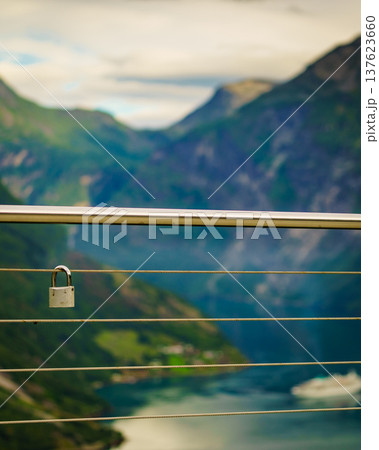 Padlock on rail and fjord view, Norway Padlock on rail and fjord view, Norway 137623660
