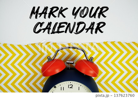 Mark Your Calendar text written on paper rip with alarm clock flat lay on yellow chevron background 137623760