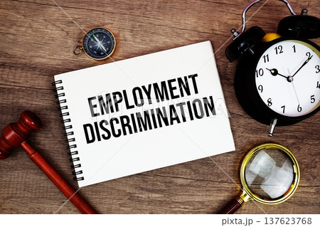 Employment Discrimination message written on notepad with alarm clock, wood gavel and magnifying glass flat lay on wooden background Employment Discrimination message written on notepad with alarm clock, wood gavel and magnifying glass flat lay on wooden background 137623768