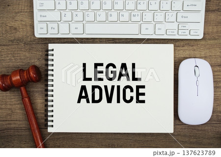 Legal Advice text written on notepad with judge gavel, keyboard and optical mouse on wooden background 137623789