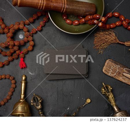 Blank black business cards in the center surrounded by a Tibetan singing bowl, prayer drum, bells Blank black business cards in the center surrounded by a Tibetan singing bowl, prayer drum, bells 137624237
