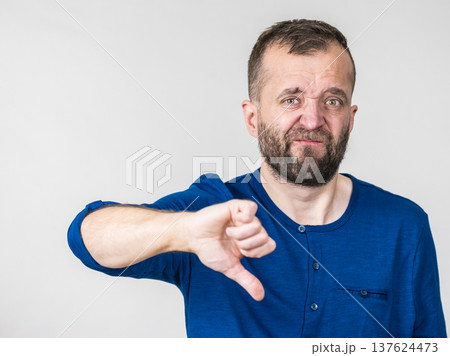 Adult man showing thumbs down gesture Adult man showing thumbs down gesture 137624473