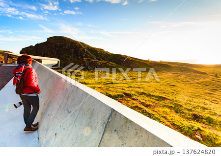 Andoya island sea coast and tourist with norwegian flag 137624820