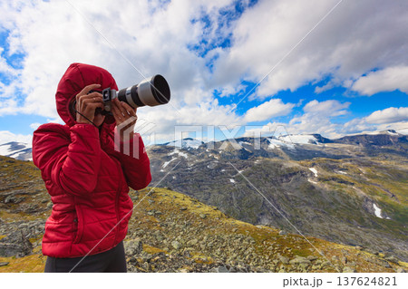 Tourist taking photo fin norwegian mountains 137624821