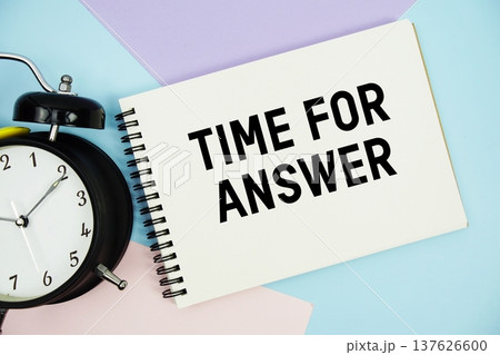Time For Answer text written on notepad with alarm clock flat lay on multicolor pastel background 137626600