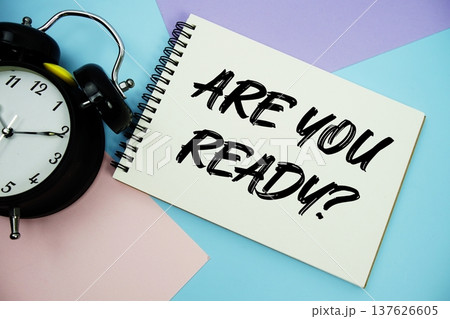 Are You Ready? text written on notepad with alarm clock flat lay on multicolor pastel background 137626605