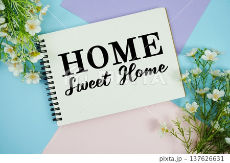 Home Sweet Home text written on notepad with flowers decorations flat lay on multicolor pastel background Home Sweet Home text written on notepad with flowers decorations flat lay on multicolor pastel background 137626631