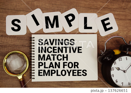 SIMPLE Savings Incentive Match Plan for Employees text on notepad with magnifying glass and alarm clock on wooden background SIMPLE Savings Incentive Match Plan for Employees text on notepad with magnifying glass and alarm clock on wooden background 137626651