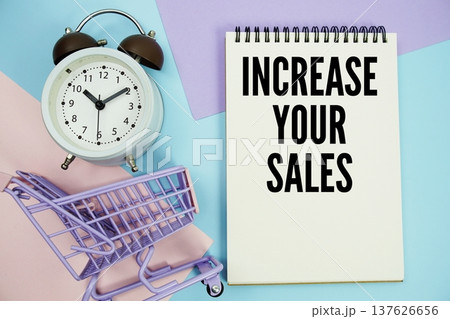 Increase Your Sales text written on notepad with alarm clock and trolley shopping cart 137626656