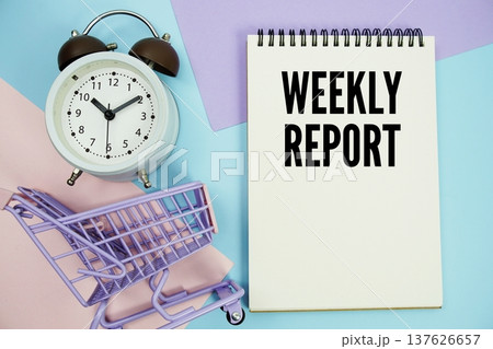 Weekly Report text written on notepad with alarm clock and trolley shopping cart Weekly Report text written on notepad with alarm clock and trolley shopping cart 137626657