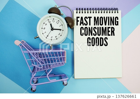 FMCG Fast Moving Consumer Goods text written on notepad with alarm clock and trolley shopping cart 137626661