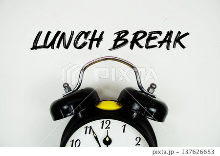 Lunch Break text with alarm clock flat lay on white background Lunch Break text with alarm clock flat lay on white background 137626683