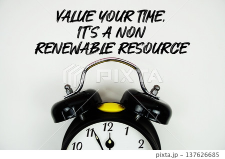 Value Your Time, It's A Non-Renewable Resource text with alarm clock flat lay on white background Value Your Time, It's A Non-Renewable Resource text with alarm clock flat lay on white background 137626685