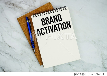 Brand Activation text written on notepad with pen on marble background 137626701