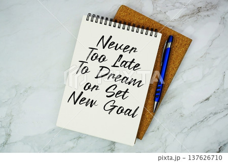Never Too Late To Dream or Set New Goal text written on notepad with pen on marble background 137626710