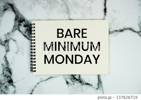 Bare Minimum Monday text written on notepad flat lay on marble background 137626719
