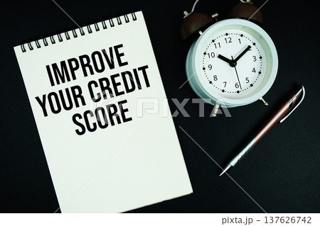 Improve Your Credit Score text written on notepad with pen and alarm clock Improve Your Credit Score text written on notepad with pen and alarm clock 137626742