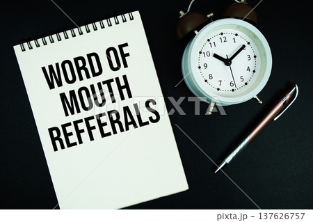 Word Of Mouth Referrals text written on notepad with pen and alarm clock Word Of Mouth Referrals text written on notepad with pen and alarm clock 137626757