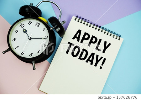 Apply Today! text written on notepad with alarm clock flat lay on multicolor pastel background Apply Today! text written on notepad with alarm clock flat lay on multicolor pastel background 137626776