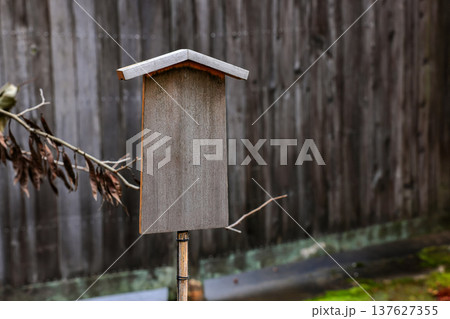 Empty retro wooden billboard in the autumn park. Signboard made of wood with space for text and graphics. Empty retro wooden billboard in the autumn park. Signboard made of wood with space for text and graphics. 137627355