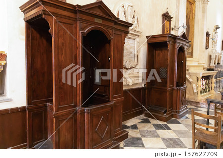 Wooden confession booths inside catholic church interior 137627709