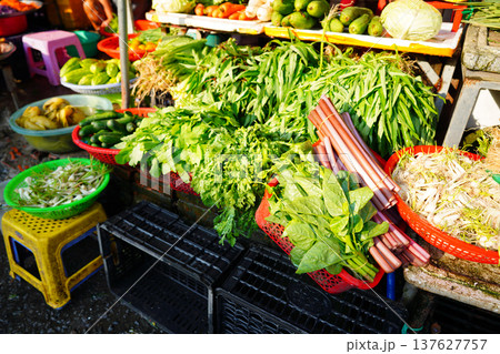 Vegetables market. Vendors display various types of fresh vegetables baskets sale in local market Vegetables market. Vendors display various types of fresh vegetables baskets sale in local market 137627757