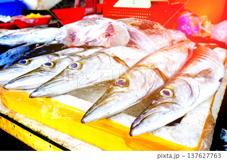 Fresh seafood in ice on counter in grocery store. Vendors display variety of sea fish. 137627763