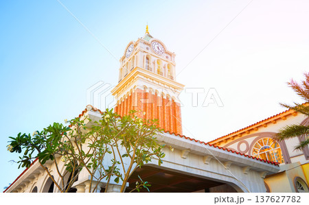 Clock tower building on sunset. Large clock tower with hour  137627782