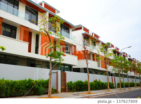 Apartments buildings in resort area. Trees on street at villa residential buildings, hotel resort 137627809