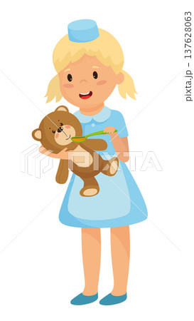 Girl Playing Nurse with Toy Bear 137628063