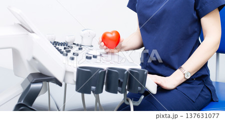 Female doctor sitting in office in a hospital with ultrasound diagnostic equipment Female doctor sitting in office in a hospital with ultrasound diagnostic equipment 137631077