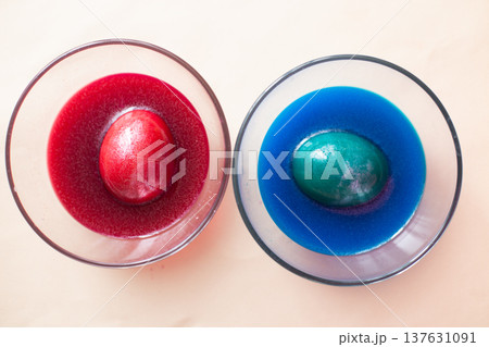 festive painted Easter eggs with colorful dyes on the table at home. 137631091