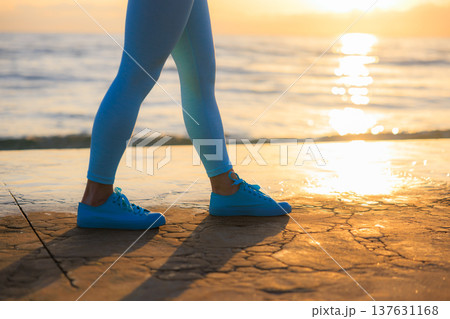 Sporty young woman is running against sea background during her vacation. Freedom and summer sport concept Sporty young woman is running against sea background during her vacation. Freedom and summer sport concept 137631168