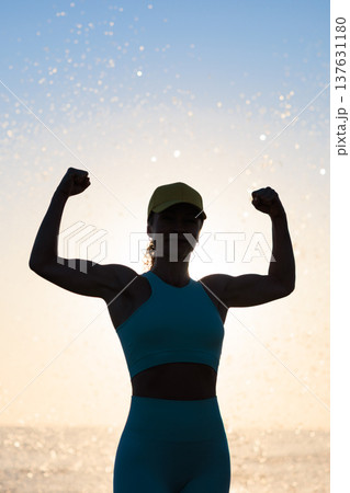 Fit young woman posing at the beach against sunrise during the summer vacation 137631180