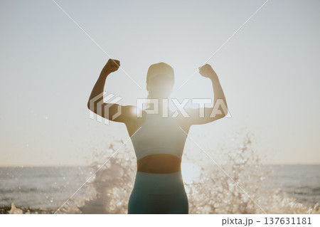 Fit young woman posing at the beach against sunrise during the summer vacation 137631181