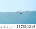 Single engine turboprop private airplane flying over green mountain landscape 137631216