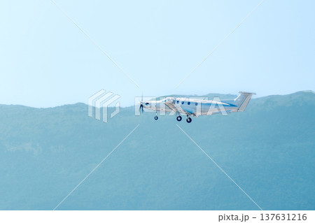 Single engine turboprop private airplane flying over green mountain landscape Single engine turboprop private airplane flying over green mountain landscape 137631216