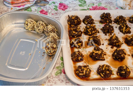 Homemade chocolate nut clusters on trays in kitchen Homemade chocolate nut clusters on trays in kitchen 137631353