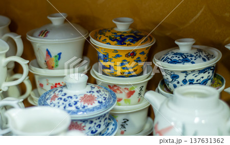 Stacked porcelain lidded tea cups with colorful patterns Stacked porcelain lidded tea cups with colorful patterns 137631362